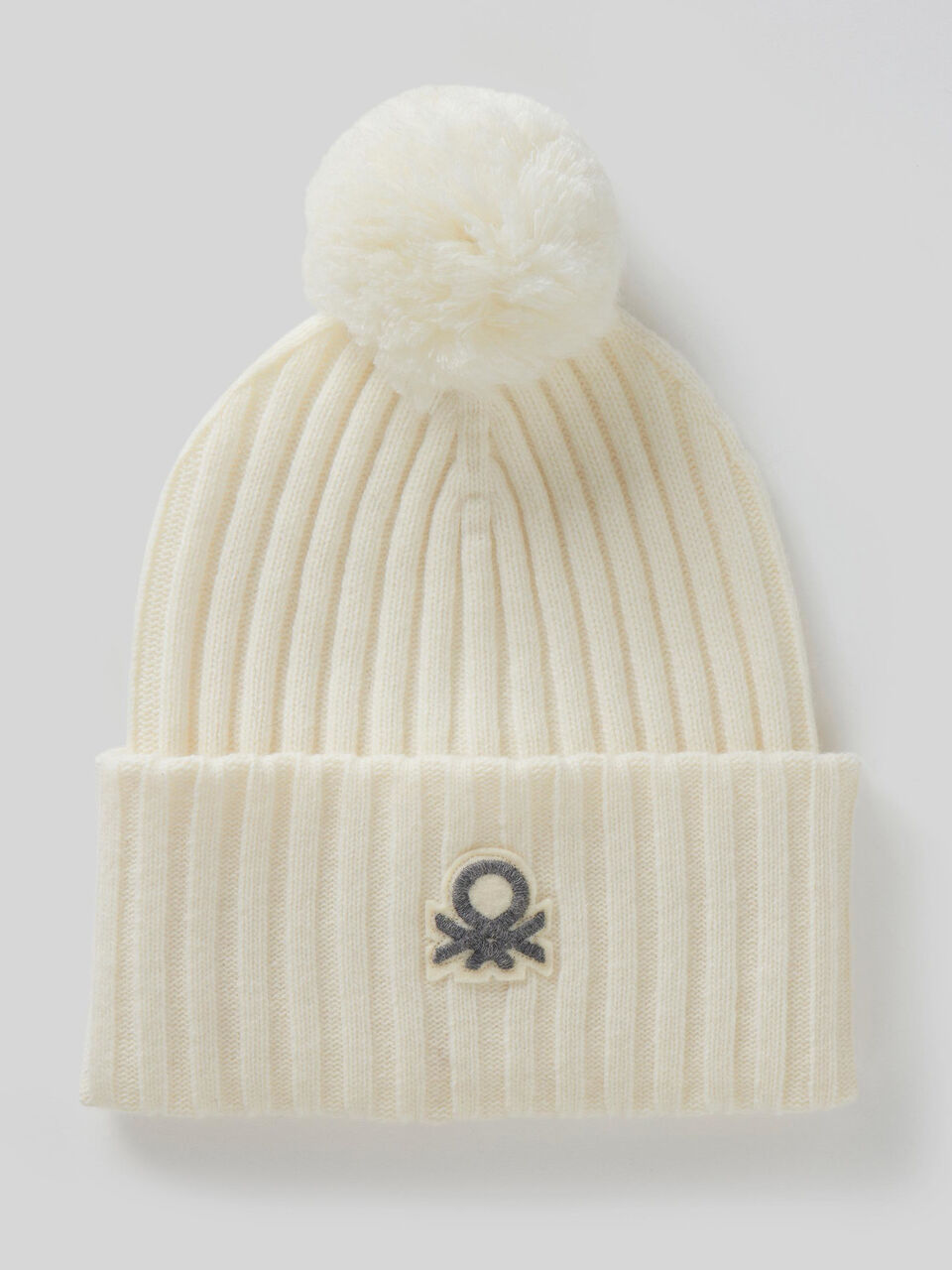 Hat with logo and pom pom image number 1