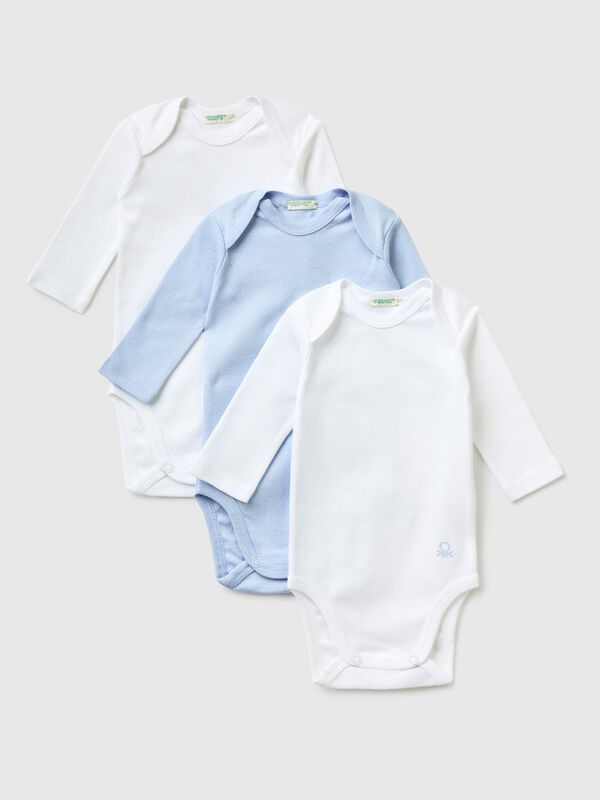 Three solid color bodysuits in organic cotton